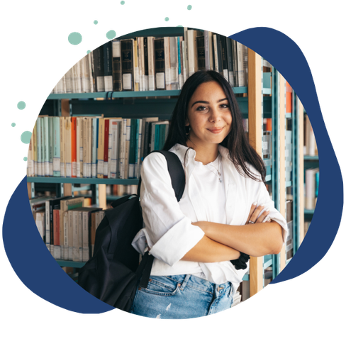 woman smiles in front of library books