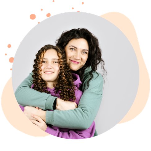 mom and daughter embrace while smiling