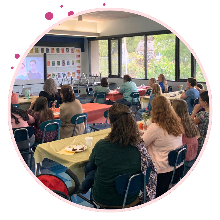 classroom of parents and daughters watch videos of Cycle Prep
