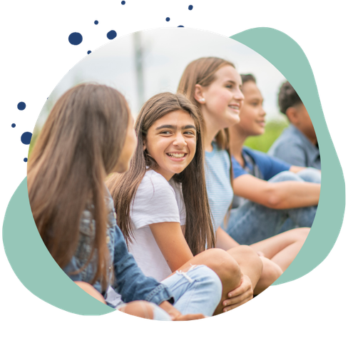 group of kids smiles sitting outside