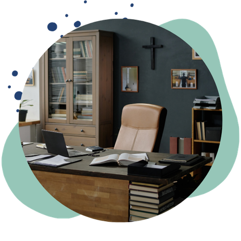 office desk with cross in background