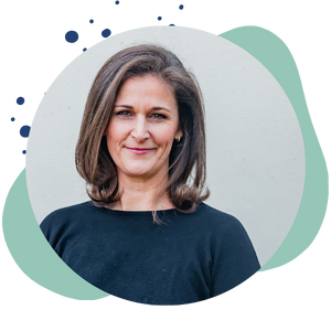 woman with blue shirt looking at camera and smiling