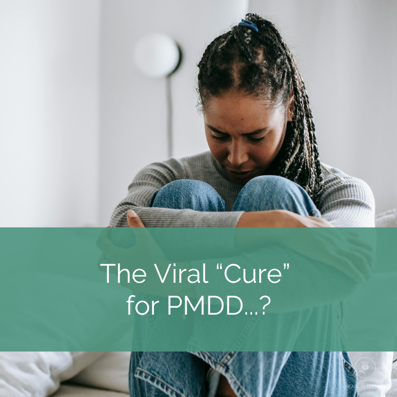 woman is curled in sitting position with text that reads "viral" cure for PMDD?